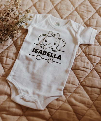Personalised baby onesie on display, featuring an elephant print and baby's name