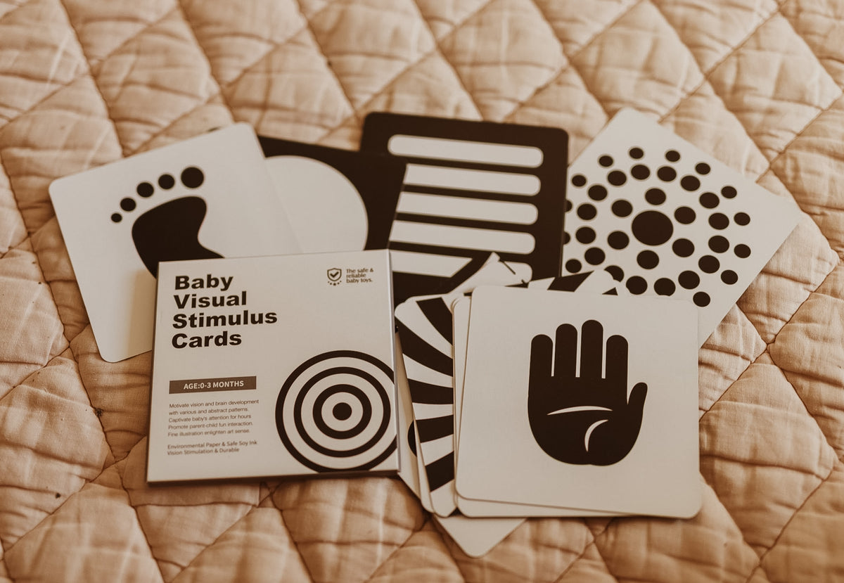 Close-up of a black and white high-contrast visual stimulus card showing the printed pattern for 0–3 month development